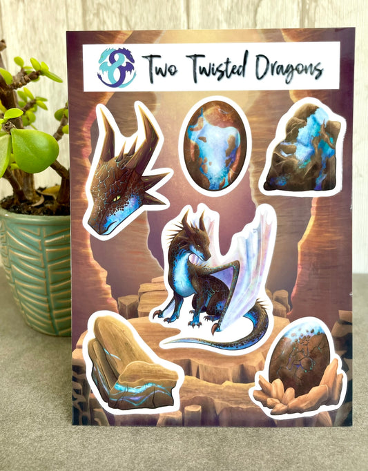 A 4x6 inch sticker sheet with 6 small different stickers featuring a sitting, side profile of a dragon that has the features of a boulder opal with hues of blue, green, purple, and pink on the underbelly and cracks of the rough, brown hue, rock scales. The wings are tucked back and are of an iridescent shimmery hue.  There is also a head of the dragon, a dragon egg, two raw opal minerals, and one cut opal gem.