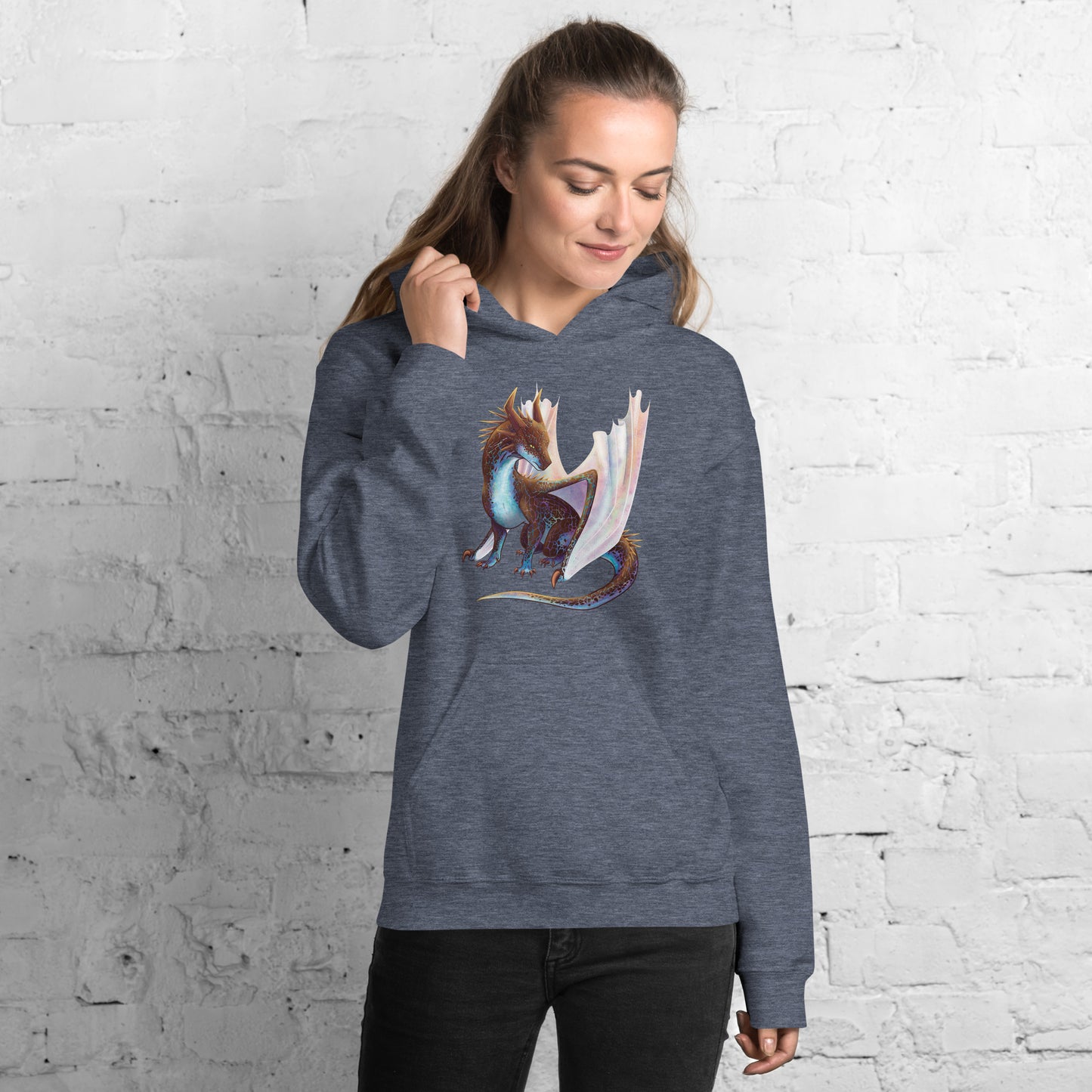 Unisex, heather dark navy in color adult hoodie with a pocket in front featuring a sitting, side profile of a dragon that has the features of a boulder opal with hues of blue, green, purple, and pink on the underbelly and cracks of the rough, brown hue, rock scales. The wings are tucked back and are of an iridescent shimmery hue