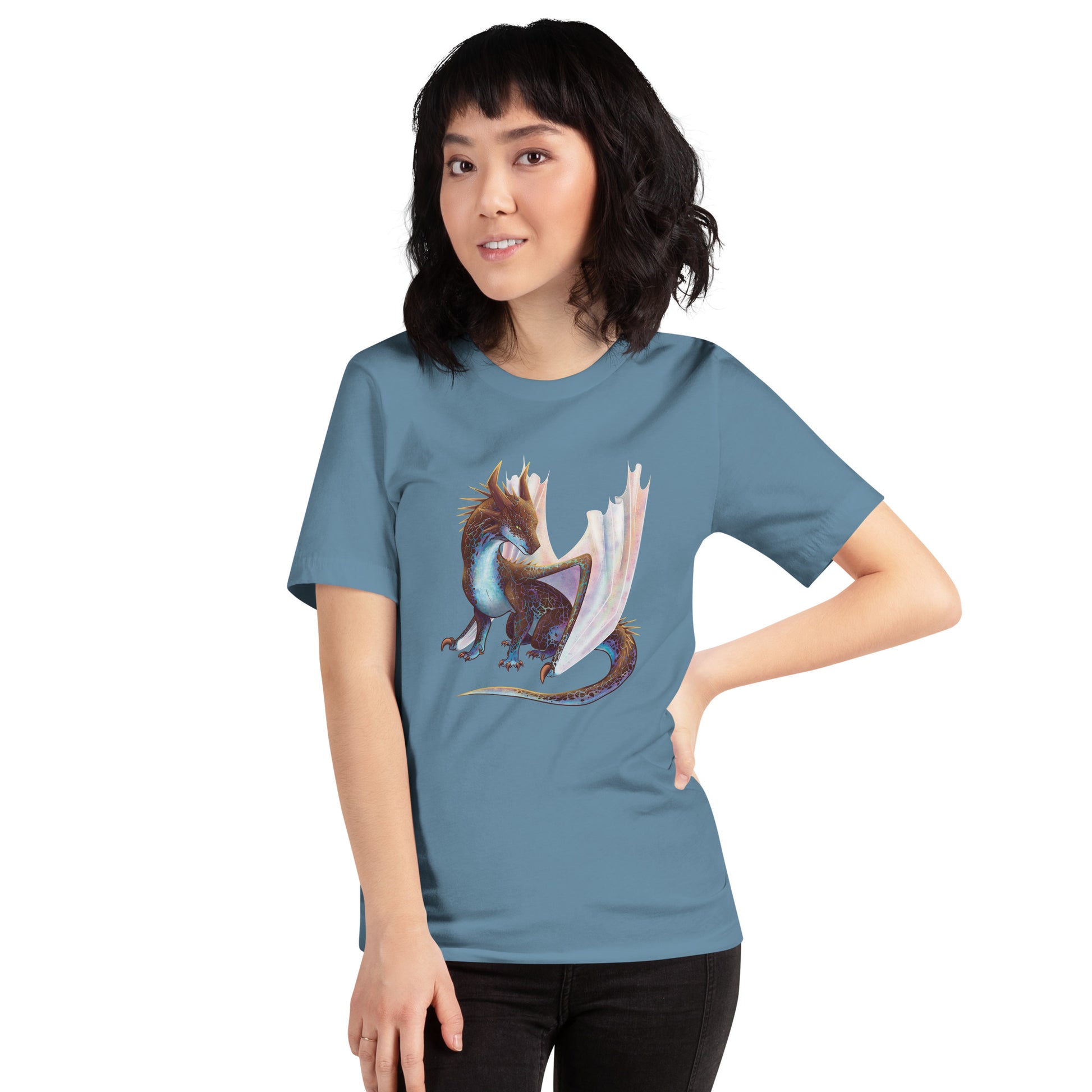 Unisex, steel blue in color adult short sleeve tee shirt featuring a sitting, side profile of a dragon that has the features of a boulder opal with hues of blue, green, purple, and pink on the underbelly and cracks of the rough, brown hue, rock scales. The wings are tucked back and are of an iridescent shimmery hue