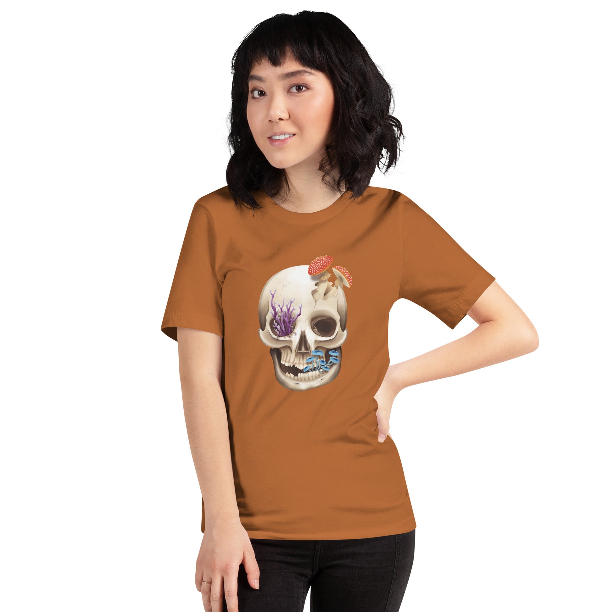 A unisex, medium burnt orange color, adult short sleeve T shirt featuring a front facing human skull with 3 different kinds of fungi growing out of it