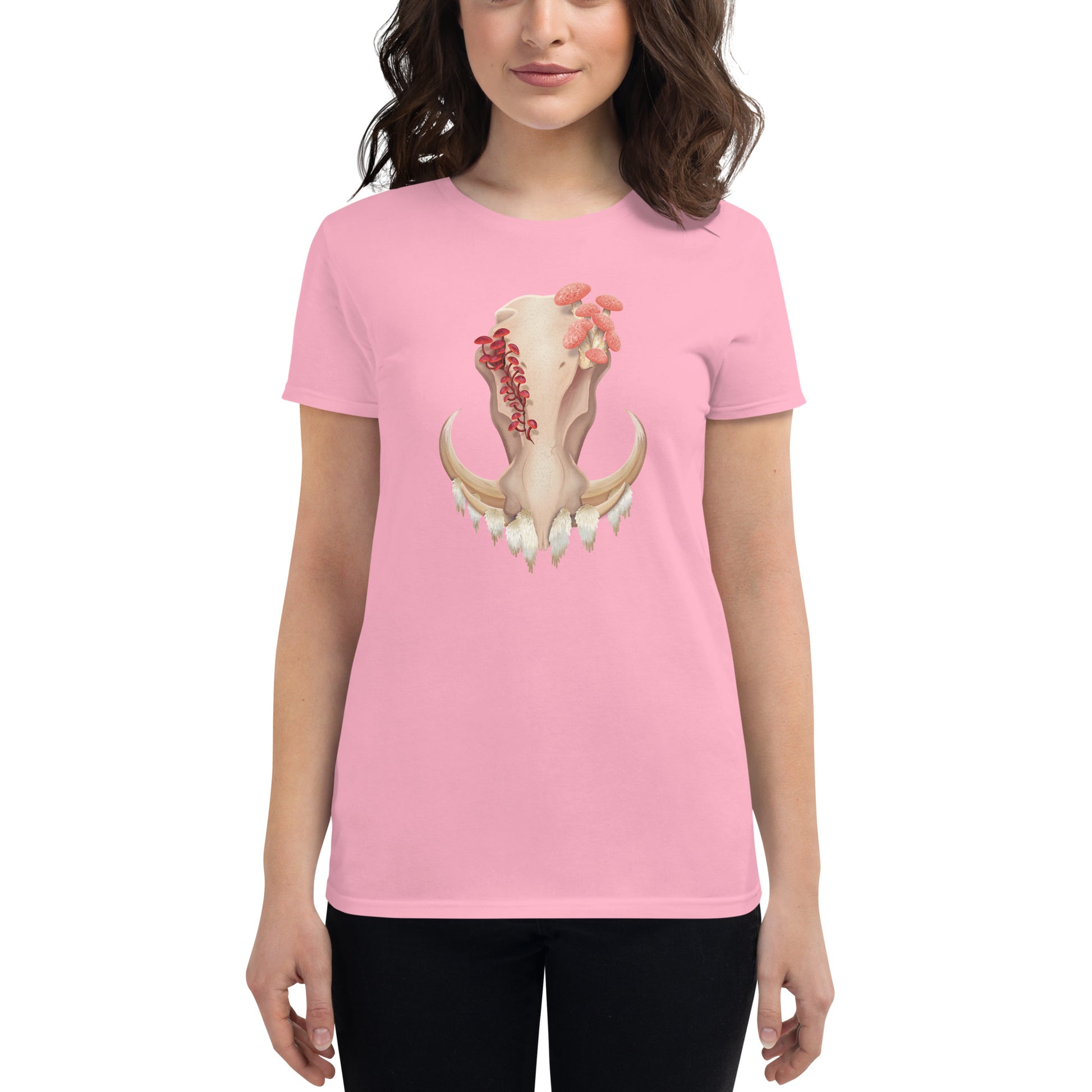 A woman wearing a fitted light pink colored T shirt featuring a front facing warthog skull with 3 different kinds of fungi growing out of it