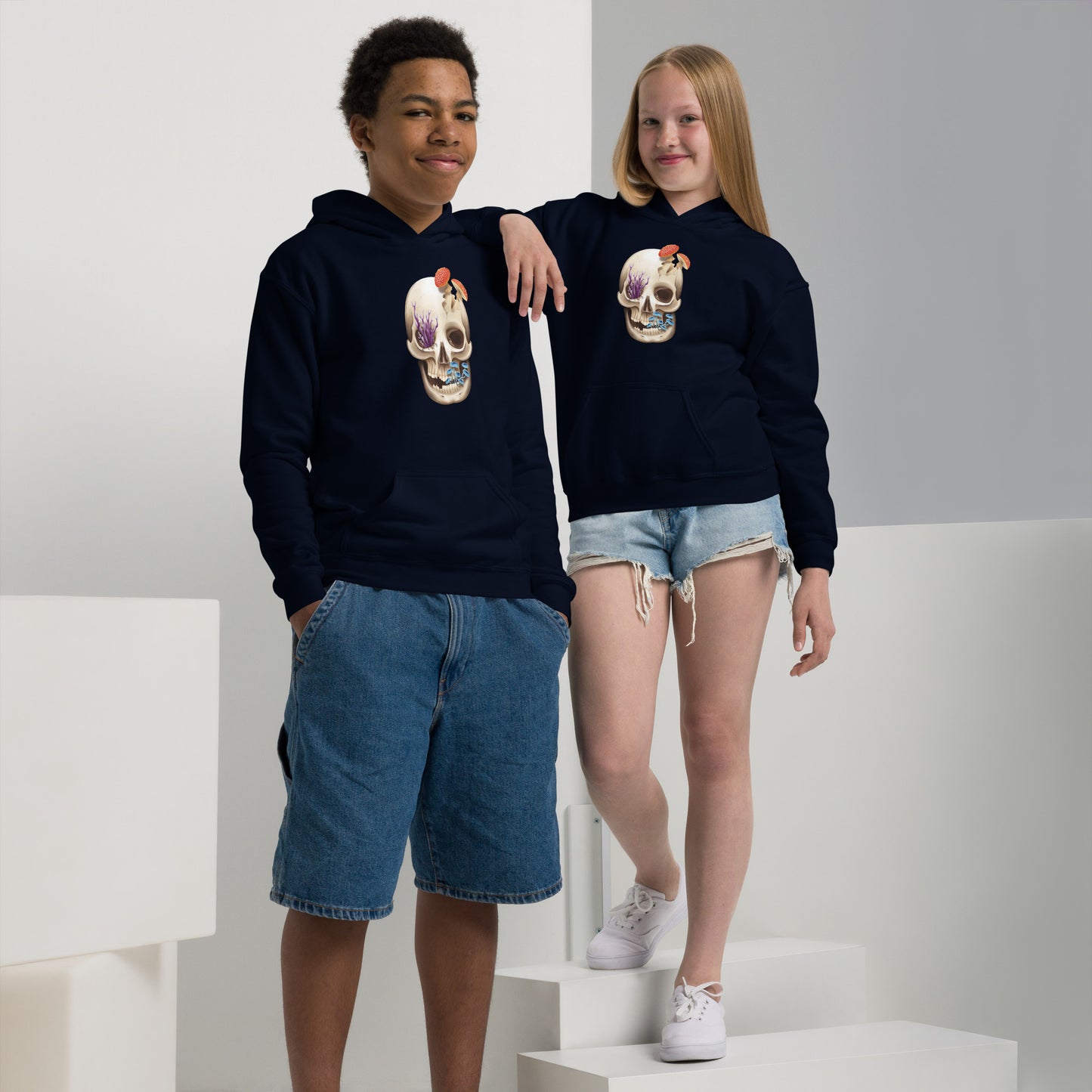 A youth sized, navy blue in color, hoodie featuring a human skull with various kinds of fungi growing out of it