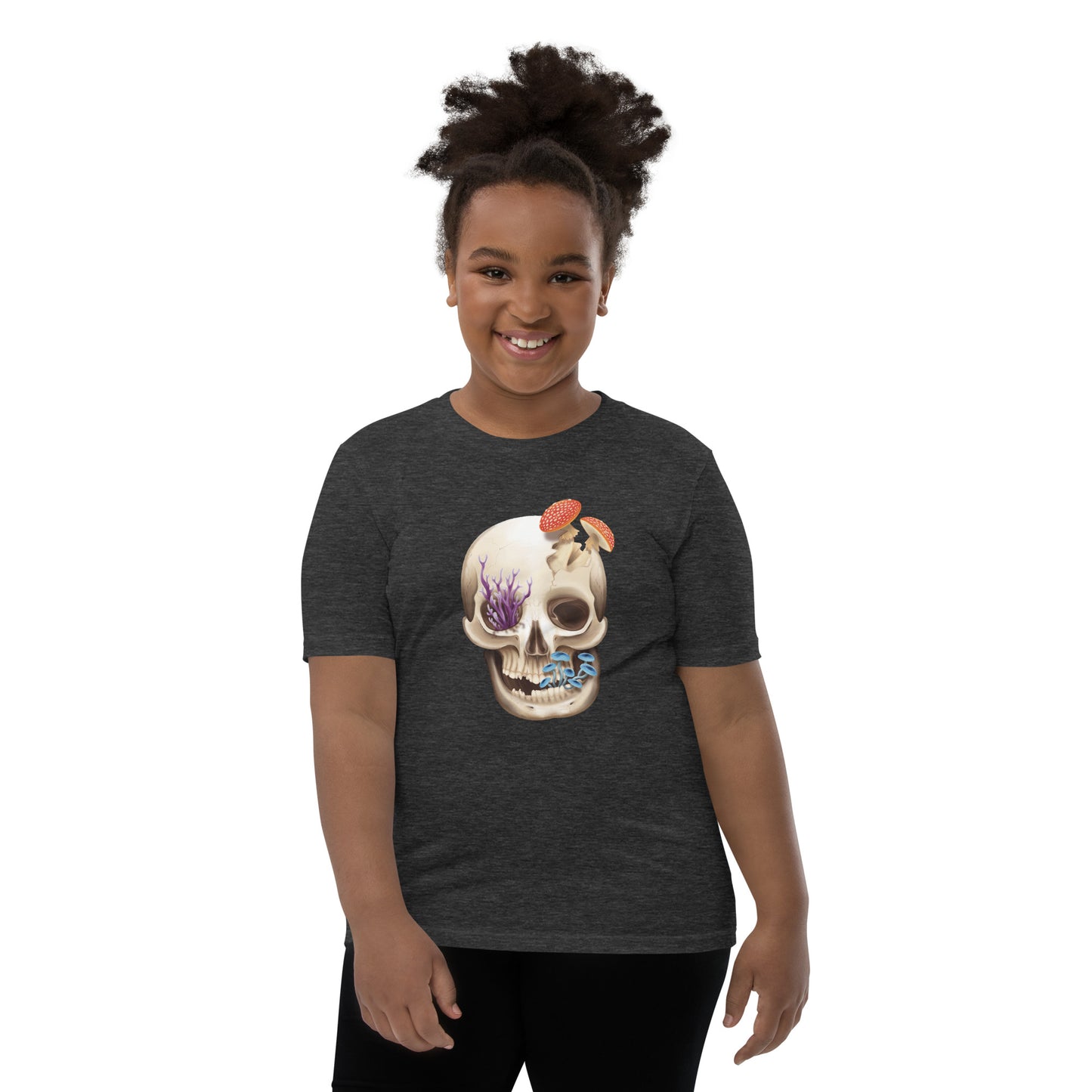 A unisex youth sized, dark heather grey in color, short sleeve t shirt featuring a human skull with various kinds of fungi growing out of it