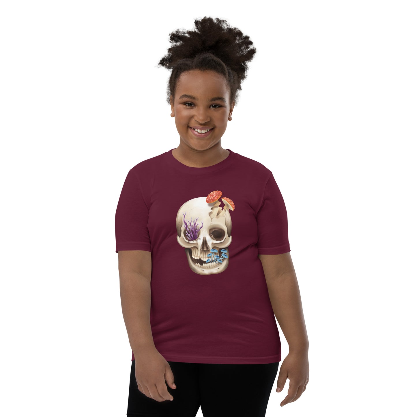 A unisex youth sized, maroon in color, short sleeve t shirt featuring a human skull with various kinds of fungi growing out of it